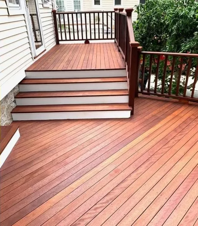 Deck Refinishing completed on a wood deck with restored boards, stairs, and railings.